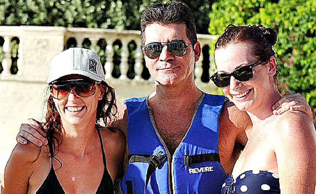Amie Partleton and Emma Baker flank entertainment guru Simon Cowell in Barbados. Amie Partleton and Emma Baker flank entertainment guru Simon Cowell in Barbados.