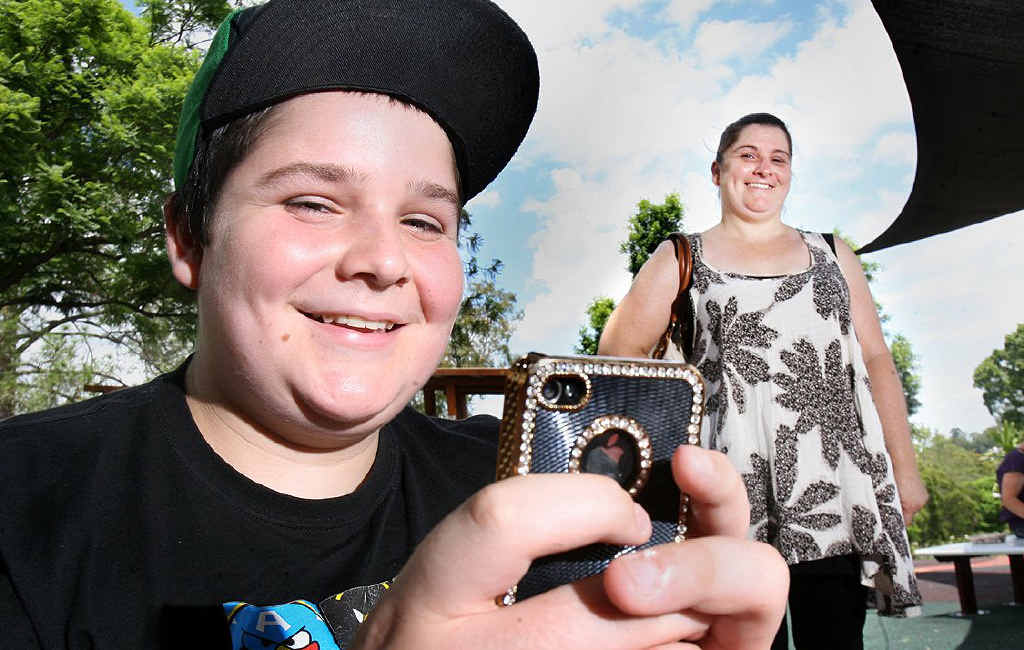 Ethan Mutzelberg, 13, from Rosewood has had a mobile phone for two years, and gets hand-me-down phones from mum Samantha Adams. Ethan Mutzelberg, 13, from Rosewood has had a mobile phone for two years, and gets hand-me-down phones from mum Samantha Adams.