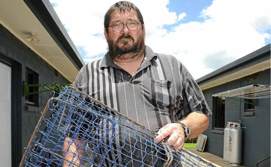 John Loveday with a crab pot in his backyard. John Loveday with a crab pot in his backyard.