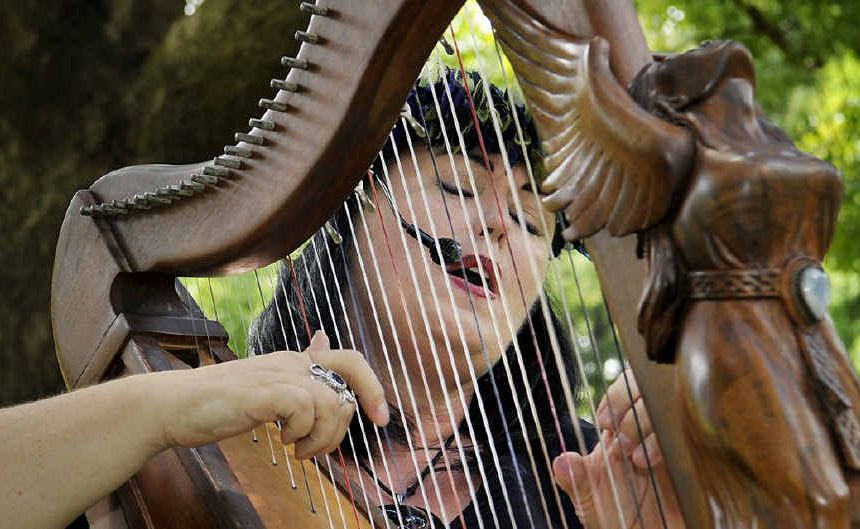Brisbane-based harpress Raven entertains the crowd with her harp ‘My Lady’ at Queens Park yesterday during the Toowoomba Regional Council’s Summer Tunes.