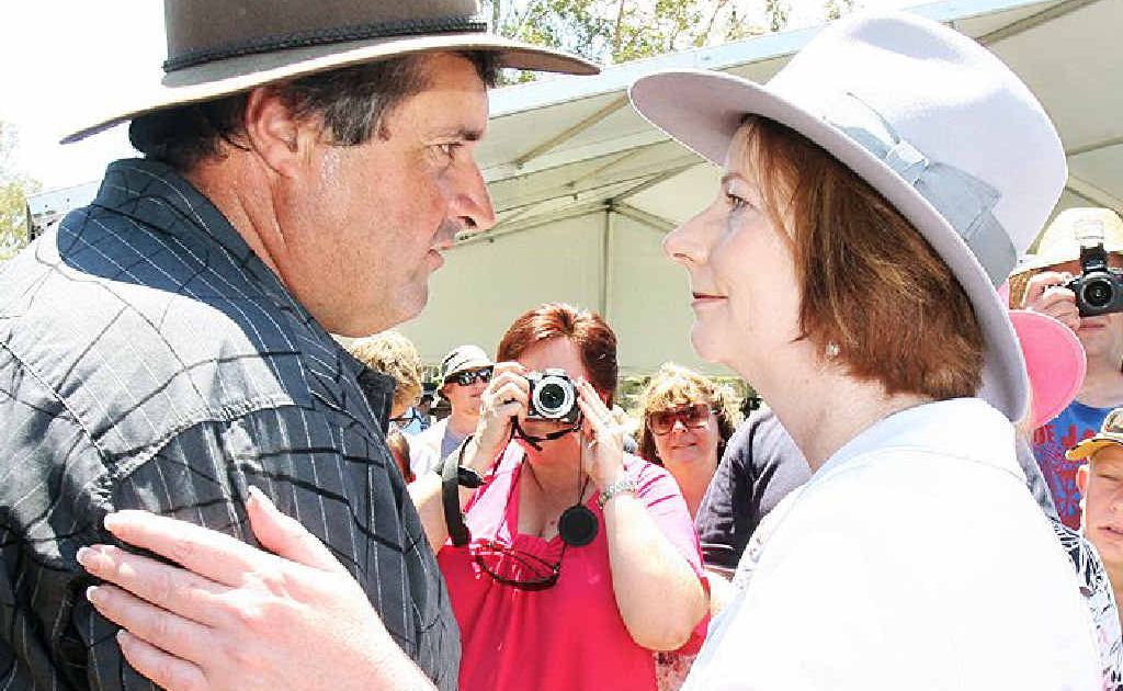 Prime Minister Julia Gillard greets a local at the Gatton commemorative flood service today. Prime Minister Julia Gillard greets a local at the Gatton commemorative flood service today.