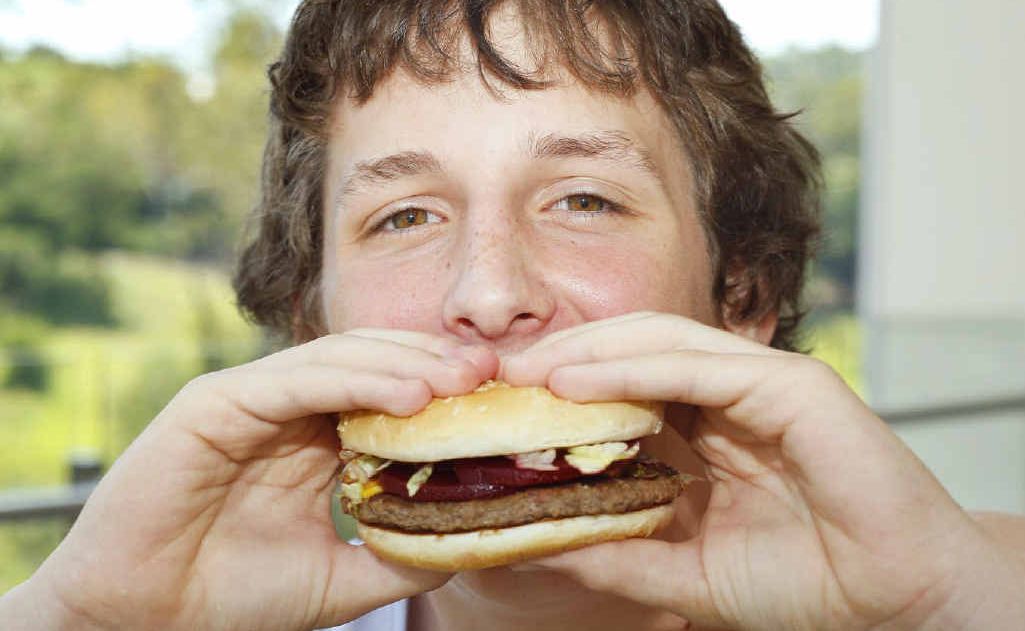 Kyle Grice, 14, of Ipswich tries one of McDonalds McOz Burgers with locally grown beetroot. Kyle Grice, 14, of Ipswich tries one of McDonalds McOz Burgers with locally grown beetroot.