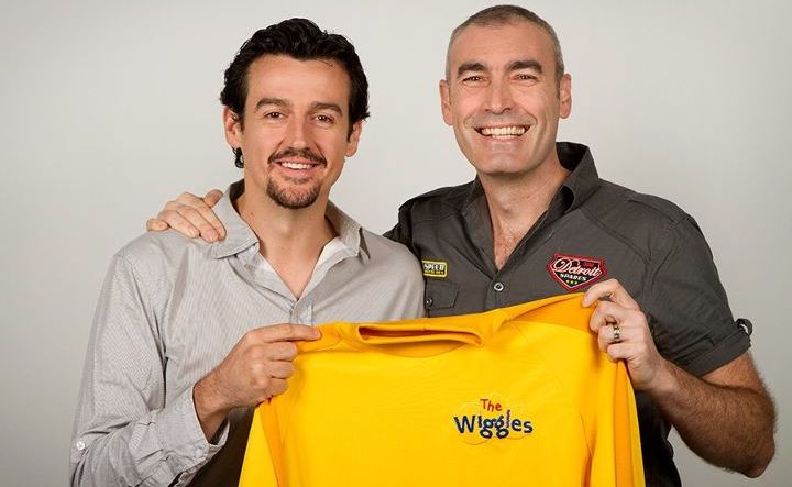 Sam Moran hands the iconic shirt back to Greg Page, the original Yellow Wiggle. Sam Moran hands the iconic shirt back to Greg Page, the original Yellow Wiggle.