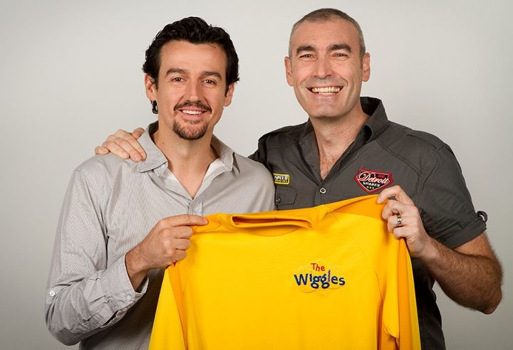 Sam Moran hands the iconic shirt back to Greg Page, the original Yellow Wiggle.