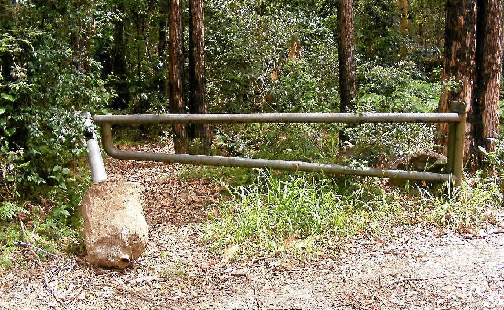 A vandalised barrier on a Yuraygir National Park fire management trail. A vandalised barrier on a Yuraygir National Park fire management trail.