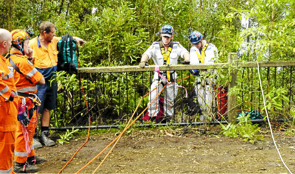 Lismore police rescue squad members prepare to abseil to a man who fell 40m from Bluckbutts Lookout in the Border Ranges National Park on Wednesday night. Lismore police rescue squad members prepare to abseil to a man who fell 40m from Bluckbutts Lookout in the Border Ranges National Park on Wednesday night.