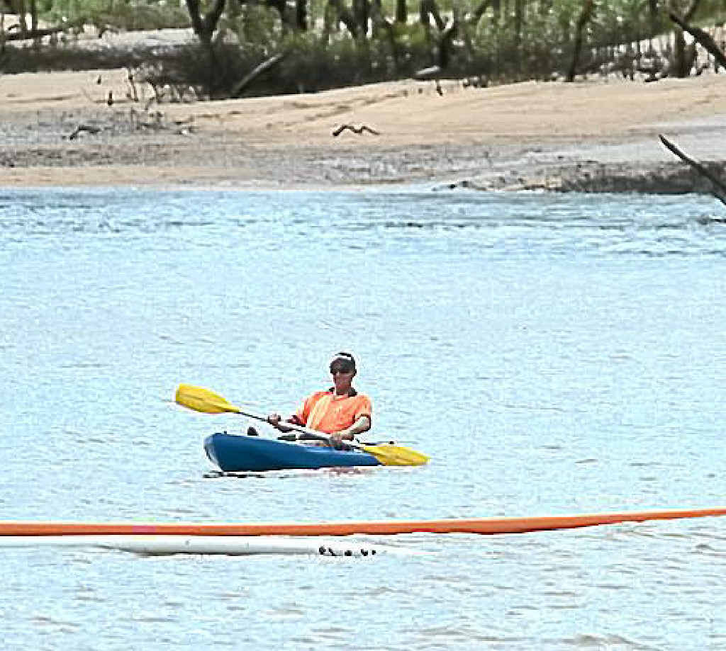 A contractor inspects cable pipes that should be under the riverbed. A contractor inspects cable pipes that should be under the riverbed.