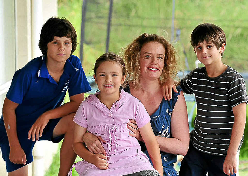OAM winner Holly Brennan with her children (from left) Zac, 11, Tyne, 7, and Jordan, 8, at home on the Sunshine Coast. OAM winner Holly Brennan with her children (from left) Zac, 11, Tyne, 7, and Jordan, 8, at home on the Sunshine Coast.