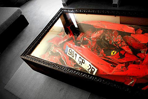 A crushed Ferrari incorporated into a coffee table. A crushed Ferrari incorporated into a coffee table.
