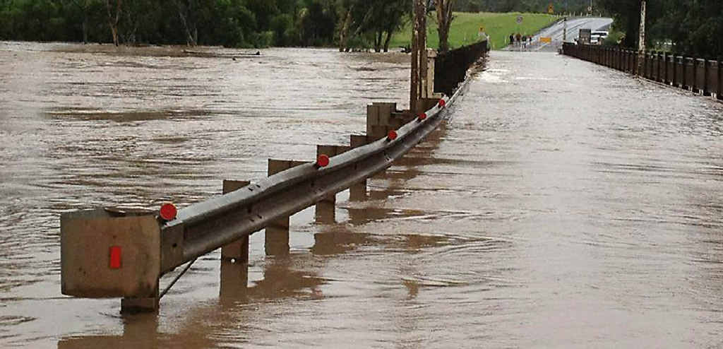 Floodwaters overwhelm Mitchell Bridge on the Warrego Hwy. Floodwaters overwhelm Mitchell Bridge on the Warrego Hwy.