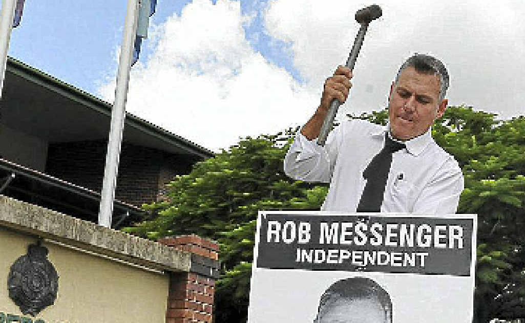 Member for Burnett Rob Messenger places one of his campaign signs outside the Bundaberg Police District Headquarters on Bourbong St. Member for Burnett Rob Messenger places one of his campaign signs outside the Bundaberg Police District Headquarters on Bourbong St.