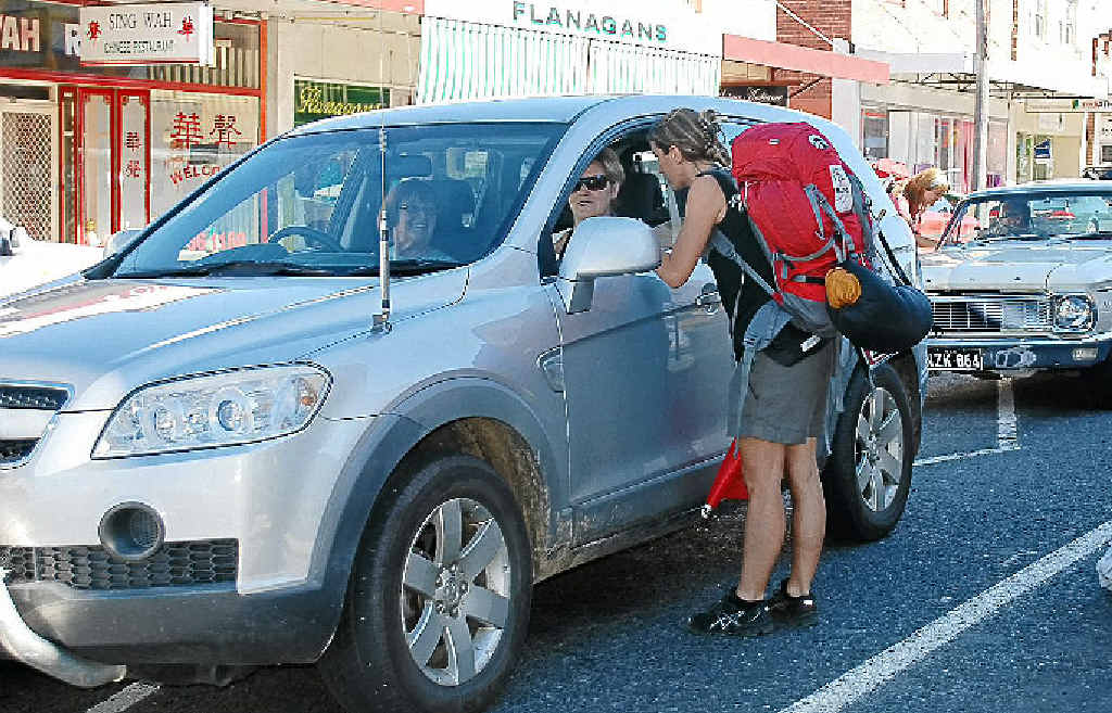 Frenchwoman Marcelle in Tenterfield attempting to hitch a ride to Tamworth. Earlier in the day Marcelle and her race teammate, Nicole, caught a ride from Byron Bay to Casino with Casino woman Fiona O’Halloran and her two daughters.