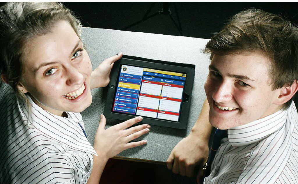 West Moreton Anglican college students Deeann Nutley and Samuel Moxon check out the school’s iPad app. West Moreton Anglican college students Deeann Nutley and Samuel Moxon check out the school’s iPad app.