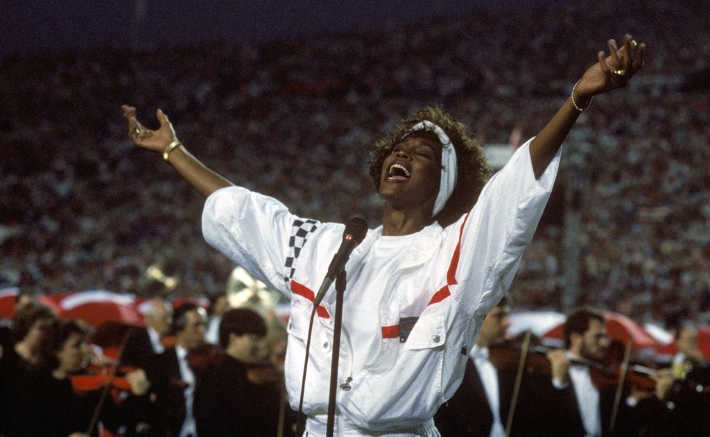 Whitney Houston sings the National Anthem before a game with the New York Giants taking on the Buffalo Bills prior to Super Bowl XXV at Tampa Stadium on January 27, 1991 in Tampa, Florida. Whitney Houston sings the National Anthem before a game with the New York Giants taking on the Buffalo Bills prior to Super Bowl XXV at Tampa Stadium on January 27, 1991 in Tampa, Florida.