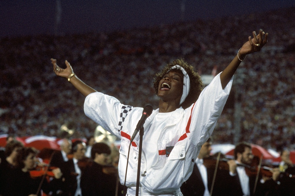 Whitney Houston sings the National Anthem before a game with the New York Giants taking on the Buffalo Bills prior to Super Bowl XXV at Tampa Stadium on January 27, 1991 in Tampa, Florida. Whitney Houston sings the National Anthem before a game with the New York Giants taking on the Buffalo Bills prior to Super Bowl XXV at Tampa Stadium on January 27, 1991 in Tampa, Florida.