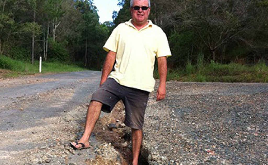 Imbil resident Ian Taylor stands at the intersection of Timani and Bryant Rds before the erosion was patched up last week. Imbil resident Ian Taylor stands at the intersection of Timani and Bryant Rds before the erosion was patched up last week.