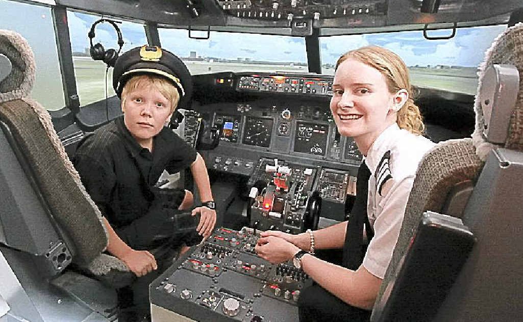 Tyler Boyd at the controls of a Boeing 737 flight simulator with his flying instructor Tess. Tyler Boyd at the controls of a Boeing 737 flight simulator with his flying instructor Tess.