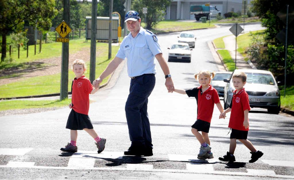 Gympie West primary school’s new Adopt-a-Cop, Constable Warwick Mundt, teaches prep students Zoe Parker, Jasmine Lowry and Tristan Bryant how to safely cross the road. Gympie West primary school’s new Adopt-a-Cop, Constable Warwick Mundt, teaches prep students Zoe Parker, Jasmine Lowry and Tristan Bryant how to safely cross the road.