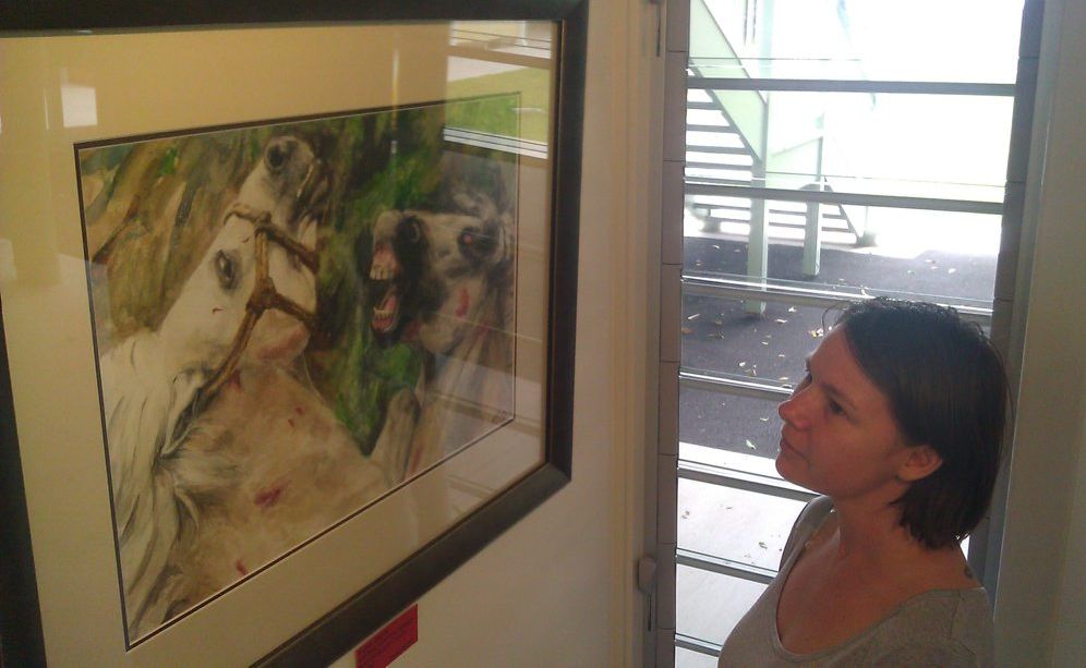 Curator Melanie Brockwell enjoys a stunning piece by local artist Fiona Curtis. The painting is part of an interactive and eclectic art exhibition featured on Kirra Hill during March. 