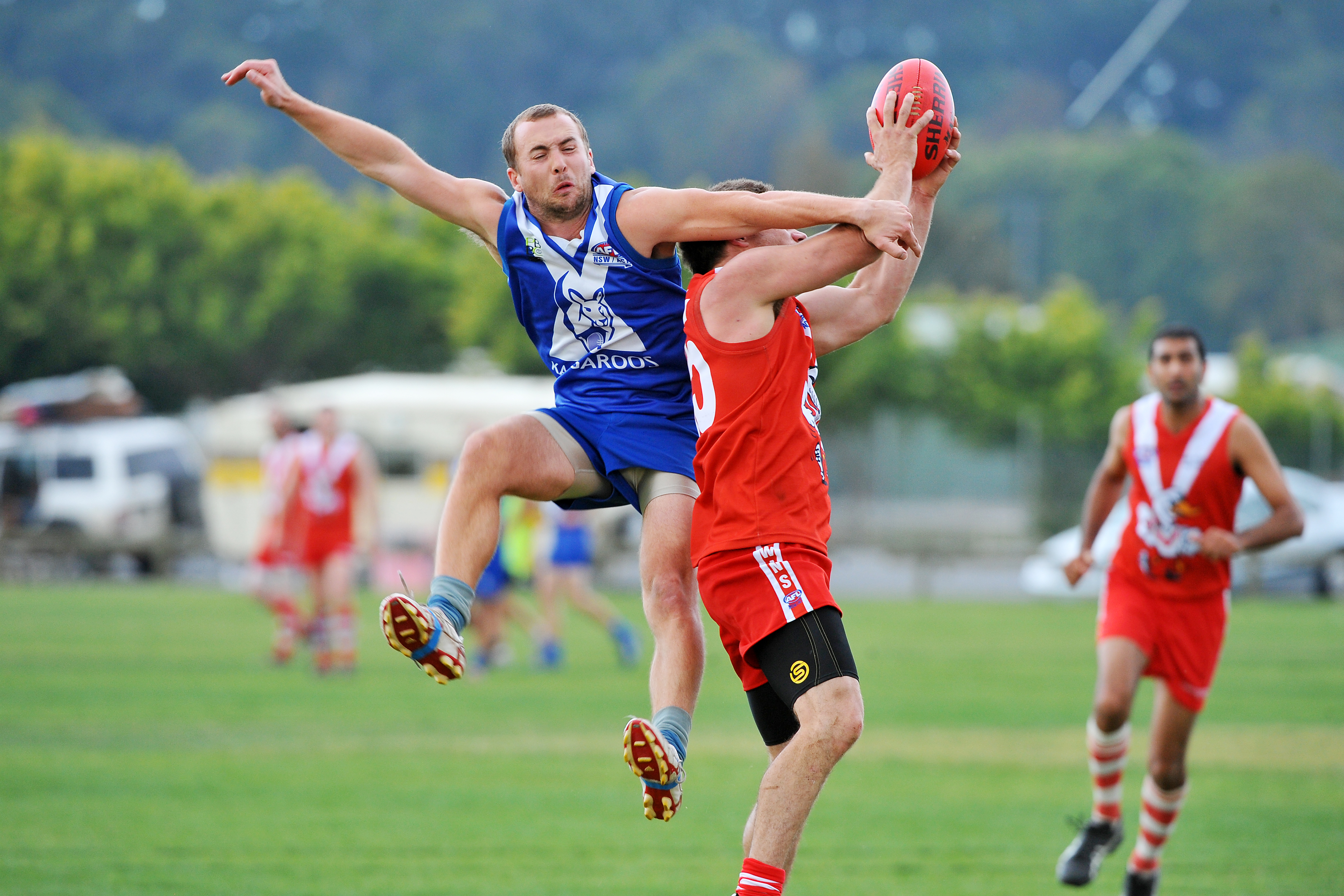 North Coffs midfielder Tom Merrick arrives too late to spoil this Coffs Swans marking attempt.