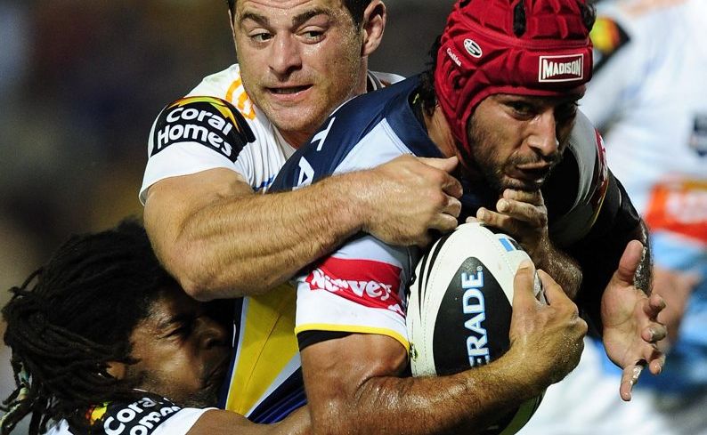 Jamal Idris and Mark Minichiello combine to halt the Cowboys Johnathan Thurston. Jamal Idris and Mark Minichiello combine to halt the Cowboys Johnathan Thurston.