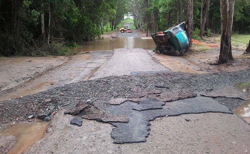 A council excavator tipped over by floodwater near Tinana Creek on Wilsons Pocket Rd. A council excavator tipped over by floodwater near Tinana Creek on Wilsons Pocket Rd.