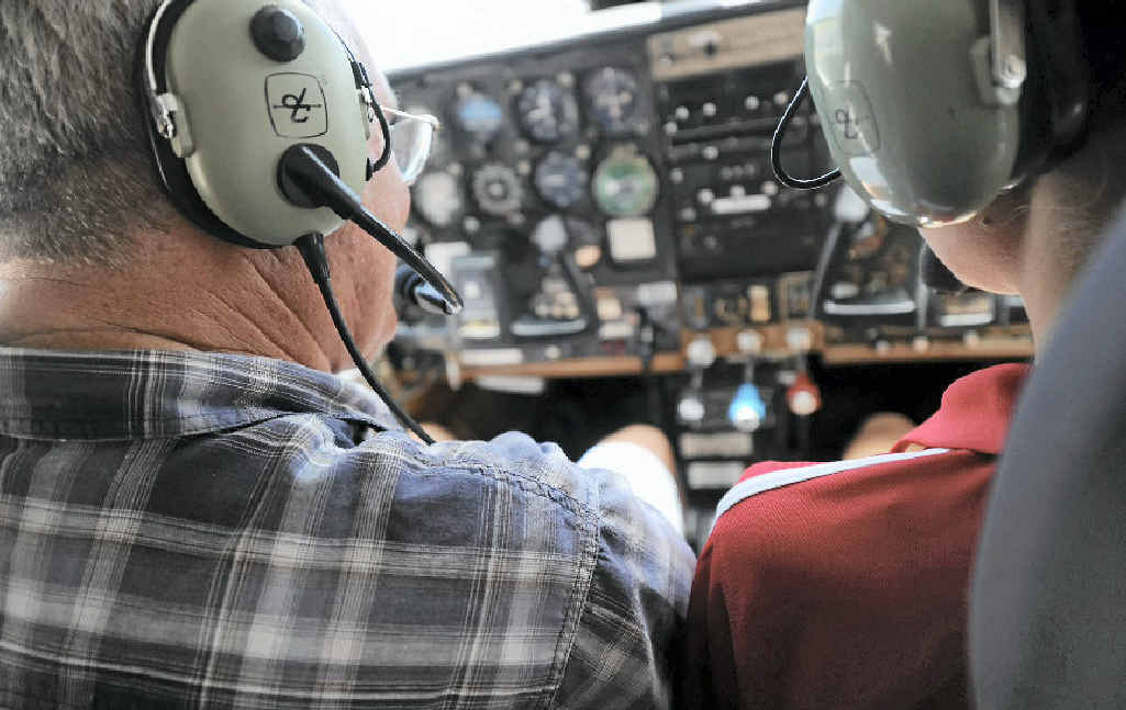 Hugh Bridge from Central Queensland Distributors shows Emily Blatchford the controls.