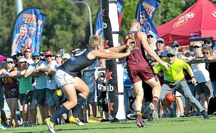 Brisbane Lions player Daniel Merrett kicks for goal. Brisbane Lions player Daniel Merrett kicks for goal.