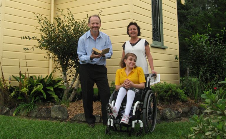 Brian Purcell with Anne Cichra and Gabbie beside the Gleniffer Church, where a fund-raising marathon reading of Oscar and Lucinda will take place this Sunday. 
