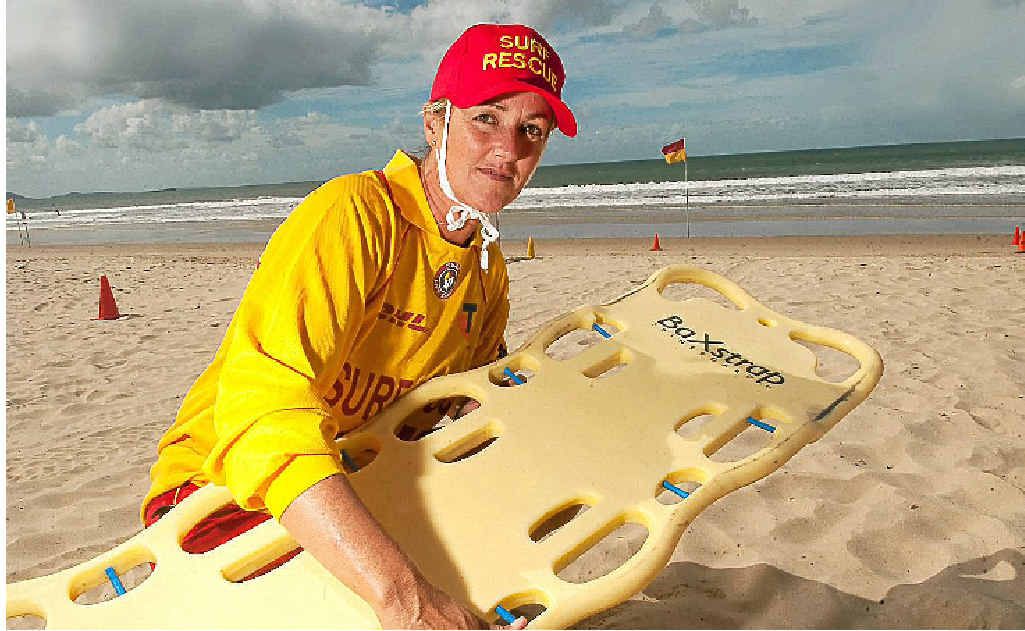 Sally Marx with a spinal board at Mooloolaba Beach. Sally Marx with a spinal board at Mooloolaba Beach.