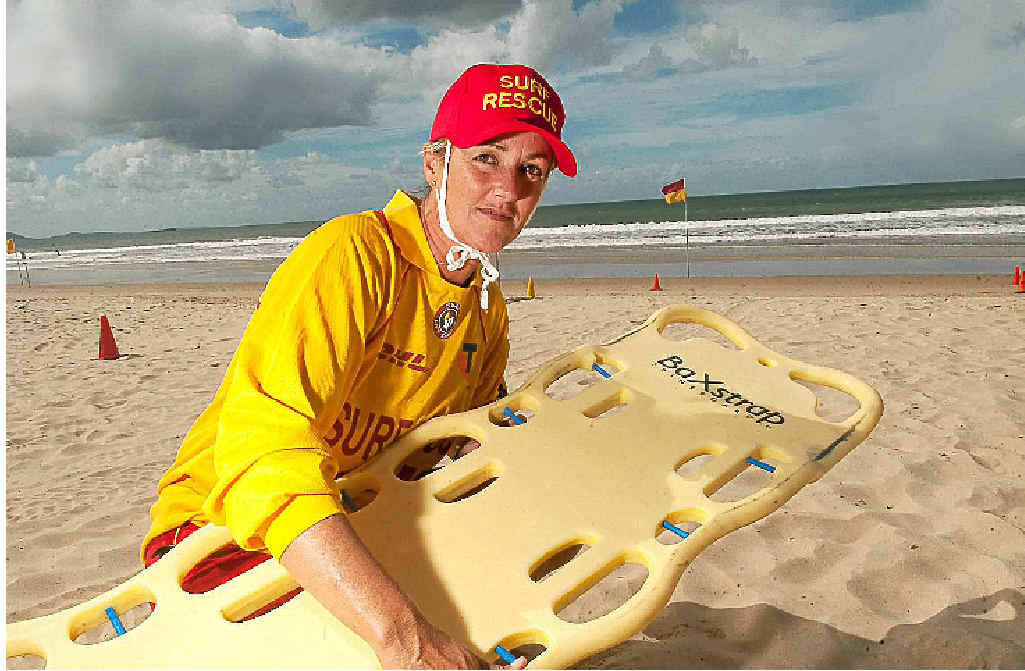 Sally Marx with a spinal board at Mooloolaba Beach. Sally Marx with a spinal board at Mooloolaba Beach.