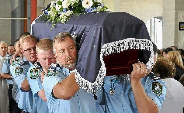 Police officers from the Oxley Area Command carry the coffin of slain officer Const David Rixon. Police officers from the Oxley Area Command carry the coffin of slain officer Const David Rixon.