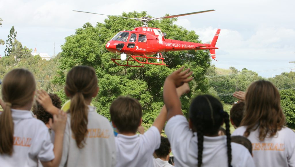 Channel Seven weatherman John Schluter arrives at Ipswich Central State School to raucous applause from the students on Thursday. 
