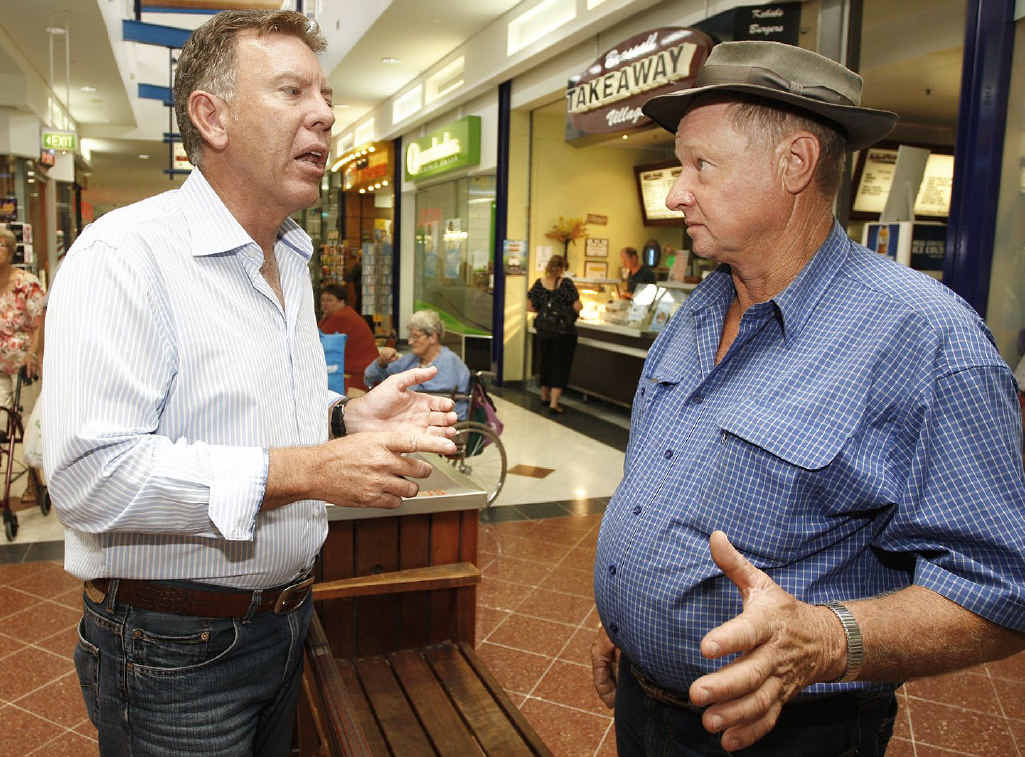 Ipswich West candidate Wayne Wendt speaks with Borallon resident Les Johnson at the Brassall Shopping Centre on Thursday.