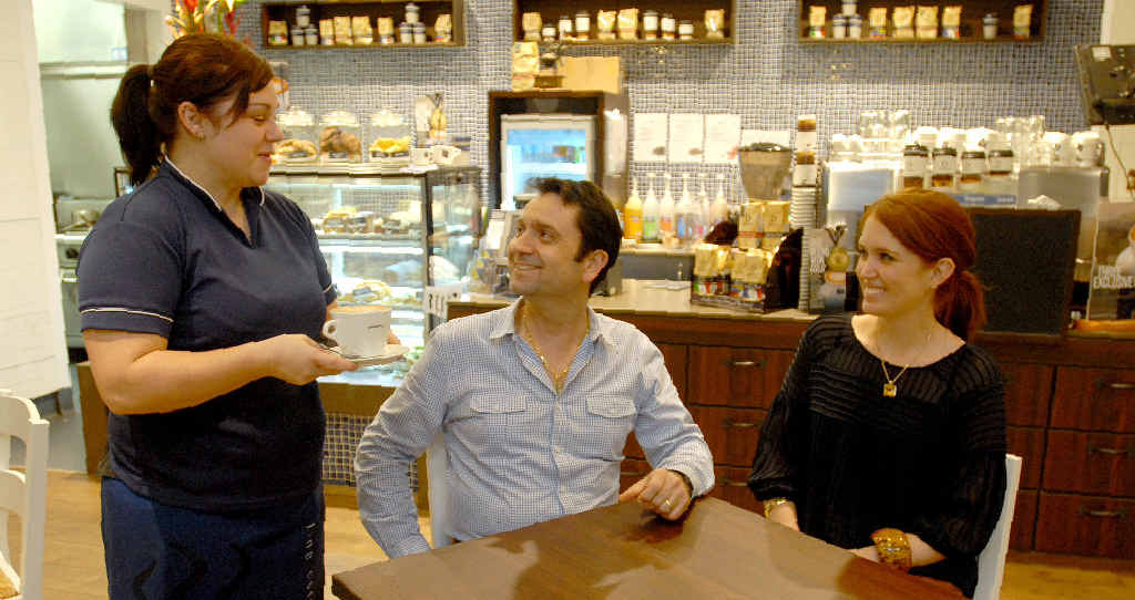 A Jamaica Blue Caneland barista serves coffee to owners Vince Lo Presti and Jocelyn Lopresti at the end of a busy day in their cafe. A Jamaica Blue Caneland barista serves coffee to owners Vince Lo Presti and Jocelyn Lopresti at the end of a busy day in their cafe.