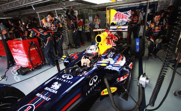 Sebastian Vettel of Germany and Red Bull Racing tries to keep cool as he prepares to drive during qualifying for the Malaysian Formula One Grand Prix Sebastian Vettel of Germany and Red Bull Racing tries to keep cool as he prepares to drive during qualifying for the Malaysian Formula One Grand Prix