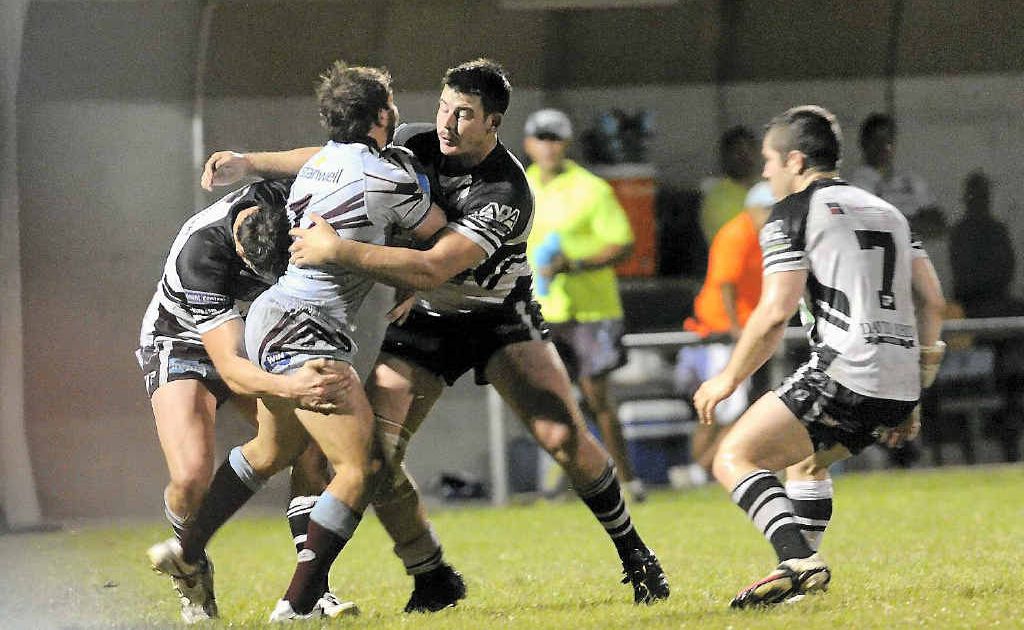 Magpies players swoop on Capras fullback Reece Baker during the Intrust Super Cup match at Marley Brown Oval. Magpies players swoop on Capras fullback Reece Baker during the Intrust Super Cup match at Marley Brown Oval.