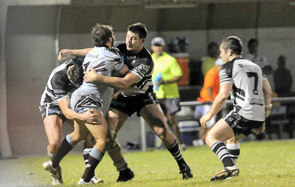 Magpies players swoop on Capras fullback Reece Baker during the Intrust Super Cup match at Marley Brown Oval. Magpies players swoop on Capras fullback Reece Baker during the Intrust Super Cup match at Marley Brown Oval.
