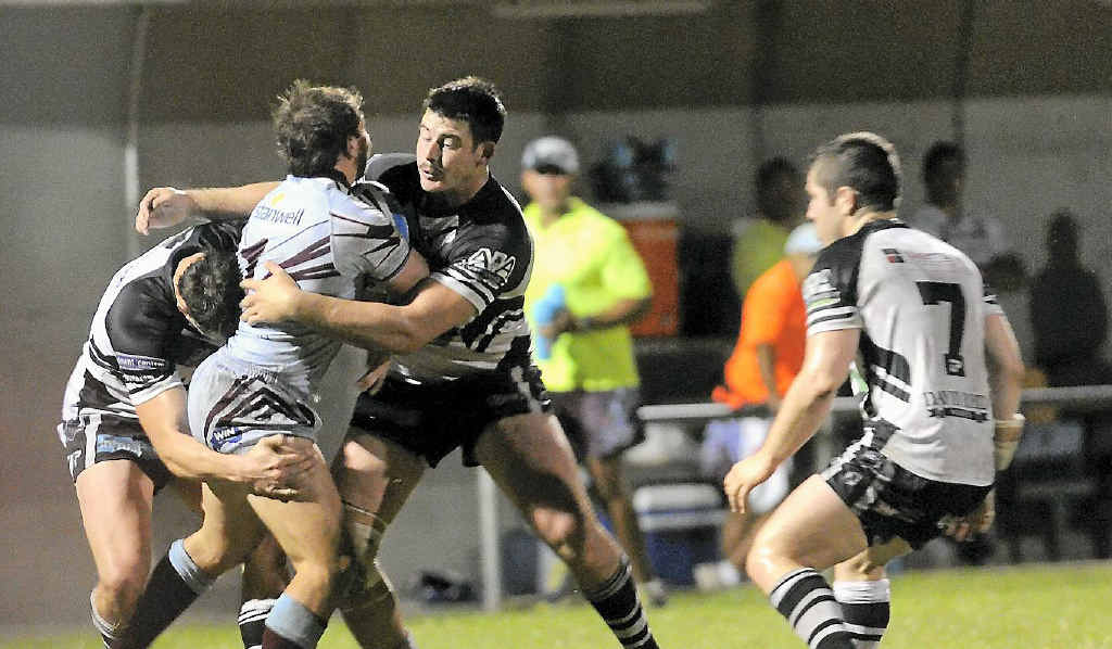 Magpies players swoop on Capras fullback Reece Baker during the Intrust Super Cup match at Marley Brown Oval. Magpies players swoop on Capras fullback Reece Baker during the Intrust Super Cup match at Marley Brown Oval.
