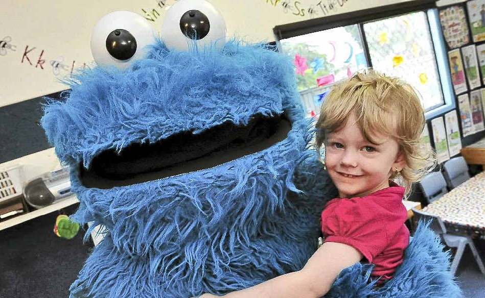 Jorja Ohlbrecht gives the Cookie Monster a cuddle at Good Start Early Learning Bundaberg on George St ahead of Elmo’s World Tour at the Moncreiff Theatre today.