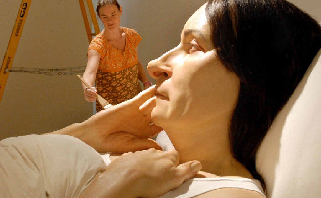 Queensland Art Gallery's modern art sculpture technician Danielle Hastie is overshadowed by the huge Ron Mueck sculpture 'In Bed'. Queensland Art Gallery's modern art sculpture technician Danielle Hastie is overshadowed by the huge Ron Mueck sculpture 'In Bed'.