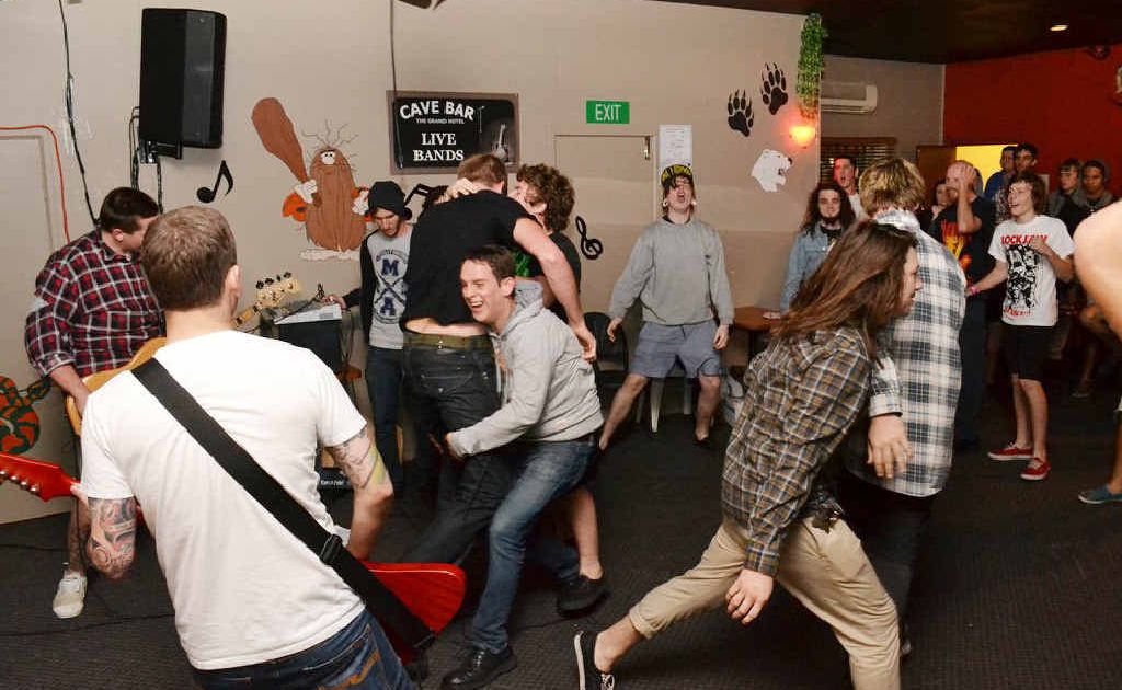 A crowd of young music lovers enjoying themselves while listening to a Rocky band inside the Cave Bar. A crowd of young music lovers enjoying themselves while listening to a Rocky band inside the Cave Bar.