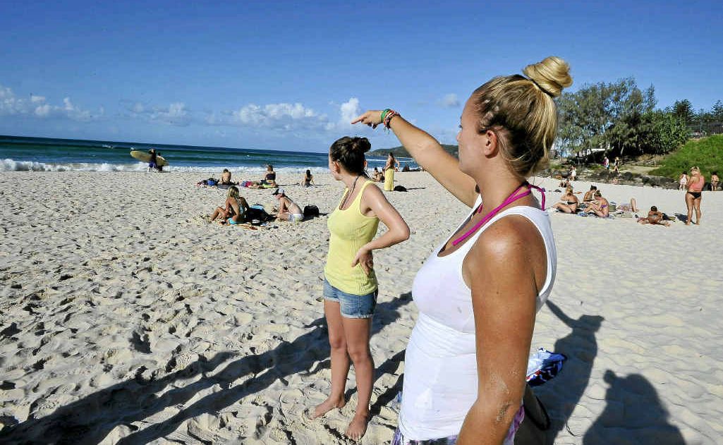 English tourists Frankie Jackson-Spence and Lisa Butler (pointing to the area where the men got into difficulties) witnessed the efforts of lifesavers to save three men. They saved one, but the other two died. English tourists Frankie Jackson-Spence and Lisa Butler (pointing to the area where the men got into difficulties) witnessed the efforts of lifesavers to save three men. They saved one, but the other two died.