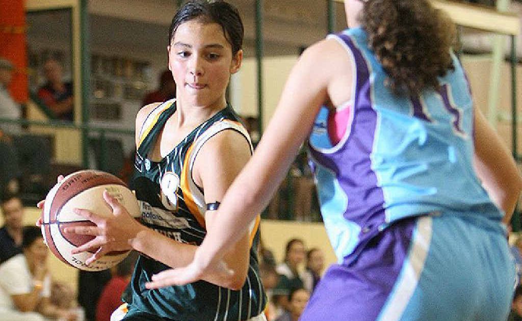 Ipswich Force player Kate Head runs at the Cairns defence during yesterday’s under-14 game at Booval. Ipswich Force player Kate Head runs at the Cairns defence during yesterday’s under-14 game at Booval.