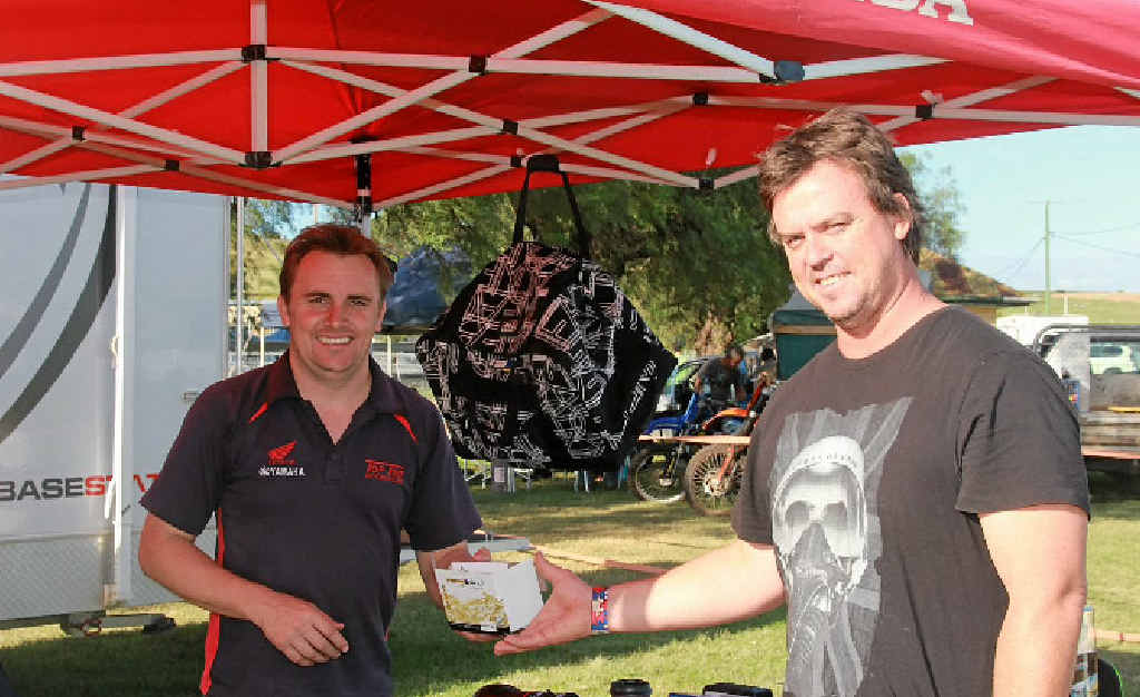 Visiting rider Peter Brown purchases parts for his bike from Border Ranges Trail Bike Ride sponsor Peter Lippi of Top two Motorcycles. Visiting rider Peter Brown purchases parts for his bike from Border Ranges Trail Bike Ride sponsor Peter Lippi of Top two Motorcycles.