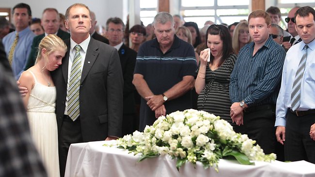 Matthew Barclay's younger sister Lauren, 12, is comforted by her dad Stephen at the funeral of the promising Maroochydore lifesaver. Photo: Cade Mooney/ Sunshine Coast Daily Matthew Barclay's younger sister Lauren, 12, is comforted by her dad Stephen at the funeral of the promising Maroochydore lifesaver. Photo: Cade Mooney/ Sunshine Coast Daily