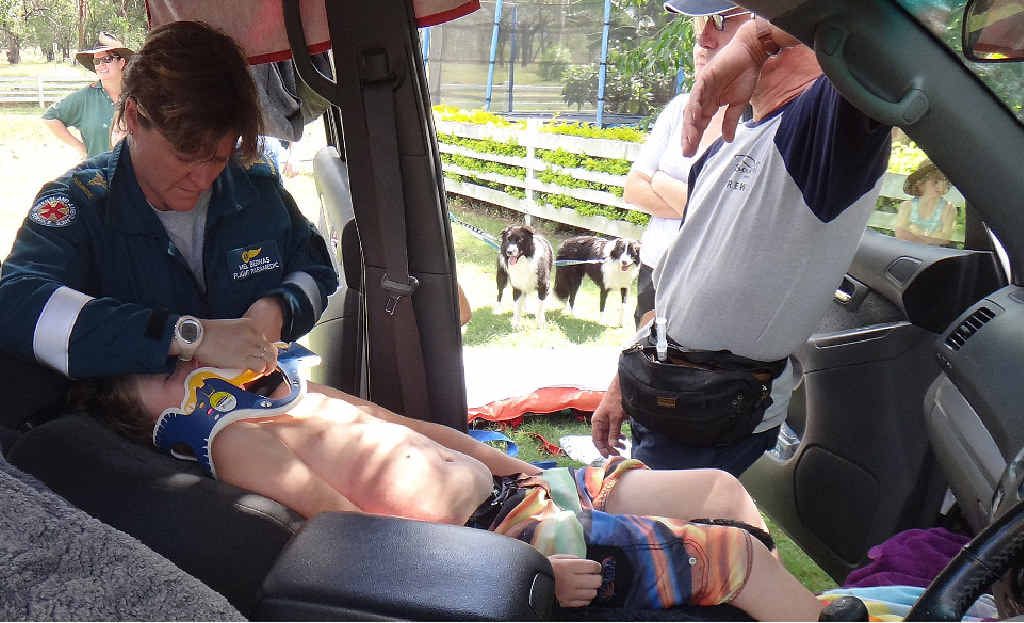 Paramedics attend to an eight-year-old boy who was sucked into a storm water drain west of Mackay. Paramedics attend to an eight-year-old boy who was sucked into a storm water drain west of Mackay.