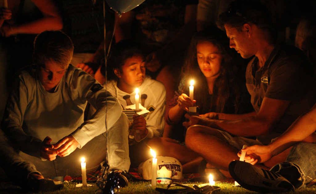 Family and friends gather at a candlelight vigil at Queens Park on Friday night, held for three Ipswich teenagers who were killed in an alleged hit and run at Goodna 12 months ago. Family and friends gather at a candlelight vigil at Queens Park on Friday night, held for three Ipswich teenagers who were killed in an alleged hit and run at Goodna 12 months ago.