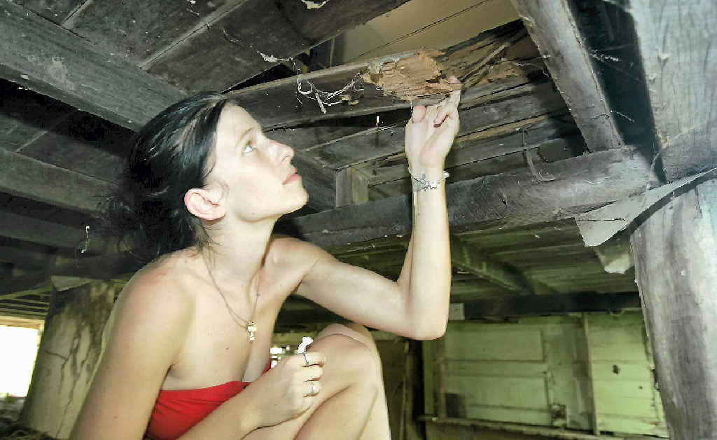 Amy Rann at the house she is renting in Mt Morgan that she claims is dangerous to live in as the floor is falling apart. Amy Rann at the house she is renting in Mt Morgan that she claims is dangerous to live in as the floor is falling apart.