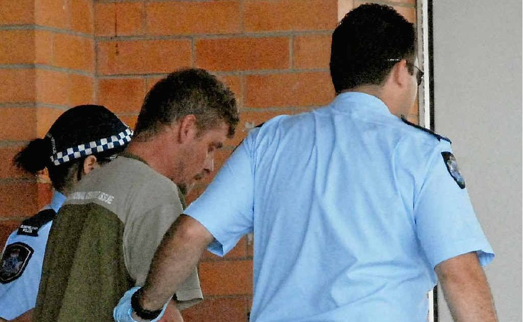 Police officers escort Chris Goulevitch into the Mackay Base Hospital after his arrest. Police officers escort Chris Goulevitch into the Mackay Base Hospital after his arrest.